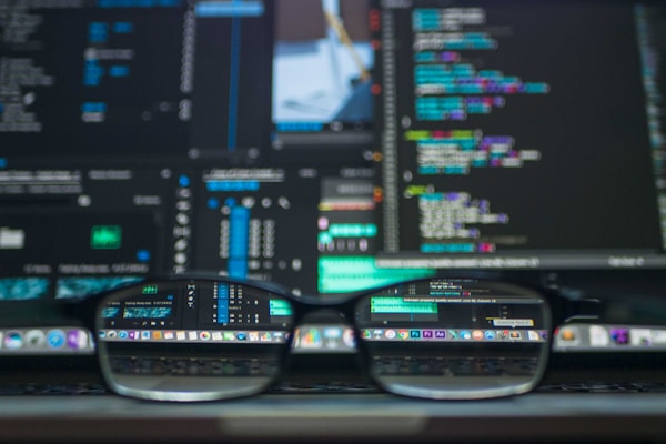 Modern workspace with code on screen representing digital solutions